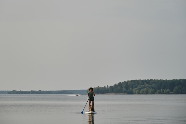 Stand up paddle with pet Concept of dog actively spending time with owner