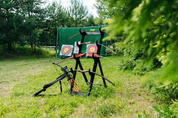 Stand with bows in the forest on the background of the target