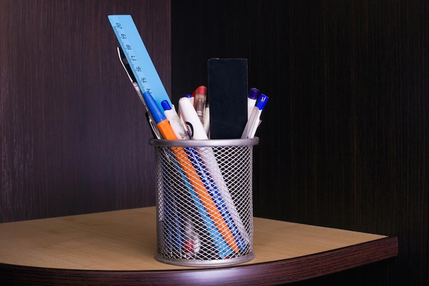 Stand with pens on the table shelf