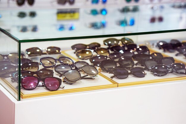 Stand with sunglasses Sunglasses backlight stand at unidentified shelf in shopping mall