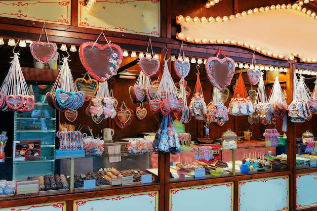 Stand with sweets in Christmas Market at Kaiser Wilhelm Memorial Church in Winter Berlin, Germany. Advent Fair Decoration and Stalls with Crafts Items on the Bazaar.