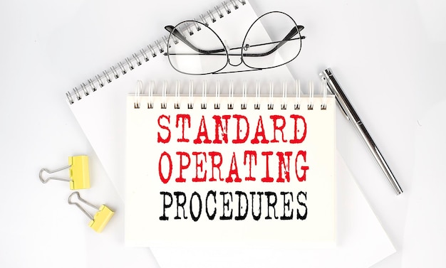 Standard Operating Procedure text on notepad  business and finance concept