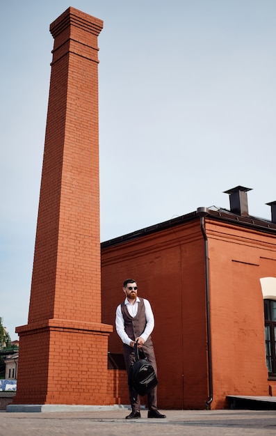 Standing character confident businessman in suit with mobile phone