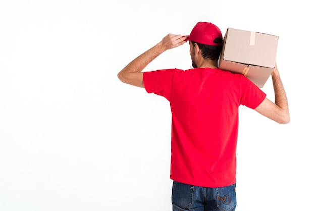 Standing courier man holding box and cap from the back shot