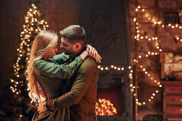 Standing and embracing each other Young lovely couple have romantic dinner indoors together