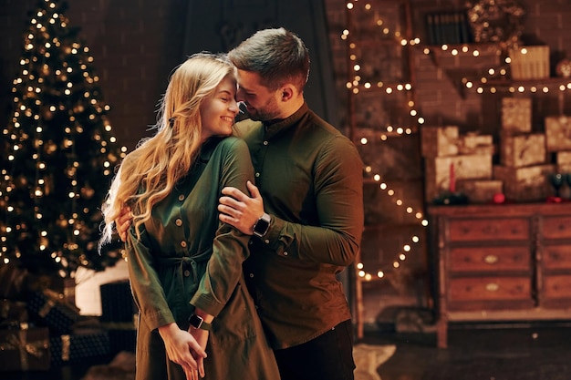 Standing and embracing each other Young lovely couple have romantic dinner indoors together