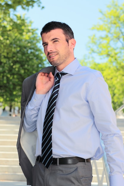 Standing man waiting outdoor in summer on stairs