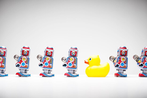 Photo standing out from the crowd tin robot rubber duck