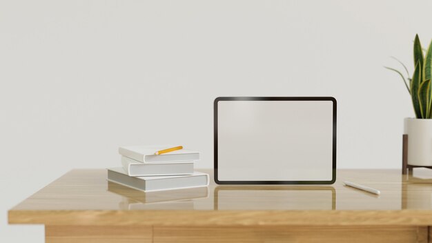 Photo standing tablet computer in blank screen with decor on modern wood table with copy space