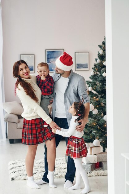 Standing together Beautiful family celebrates New year and christmas indoors at home