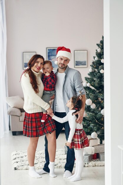 Standing together Beautiful family celebrates New year and christmas indoors at home