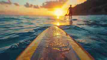 Photo standing up paddle boarding at sunset on a quiet sea legs close up