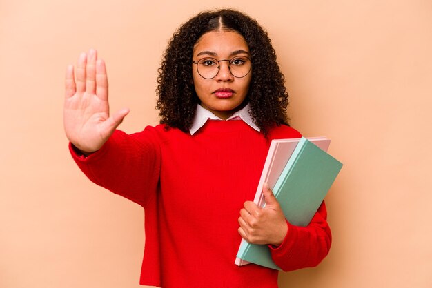 Standing with outstretched hand showing stop sign preventing you