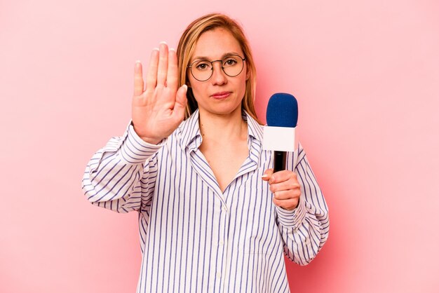 Standing with outstretched hand showing stop sign preventing you