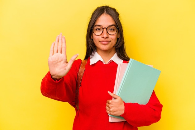 Standing with outstretched hand showing stop sign preventing you