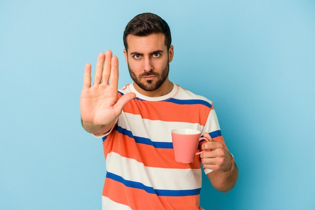 Standing with outstretched hand showing stop sign preventing you