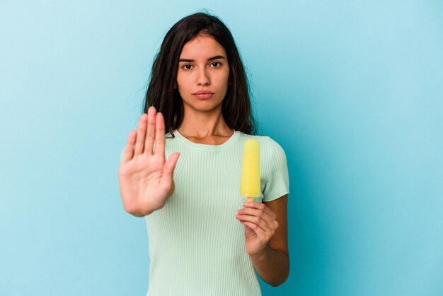 Standing with outstretched hand showing stop sign preventing you