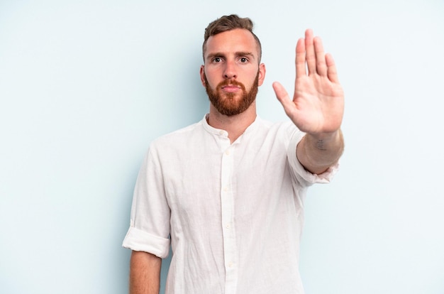 Standing with outstretched hand showing stop sign preventing you