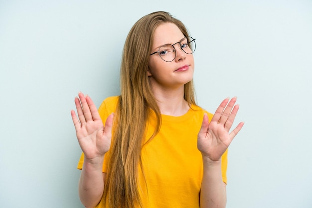 Standing with outstretched hand showing stop sign preventing you