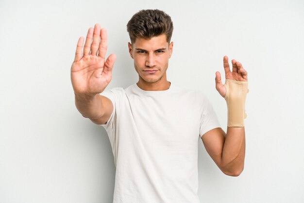 Standing with outstretched hand showing stop sign preventing you