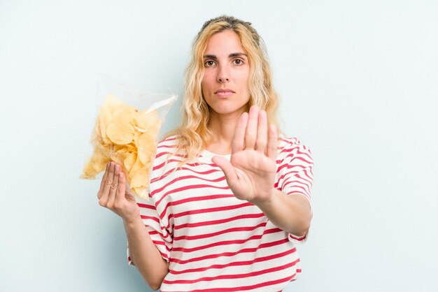 Standing with outstretched hand showing stop sign preventing you