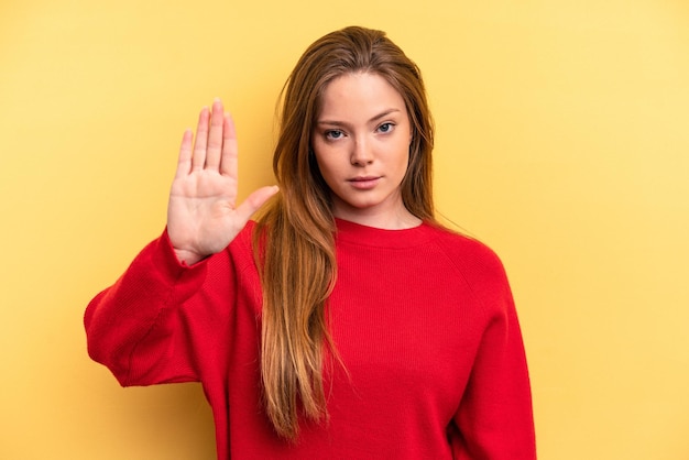 Standing with outstretched hand showing stop sign preventing you