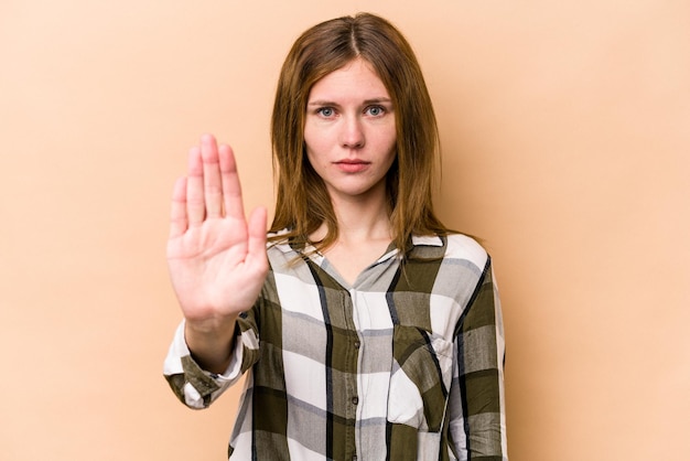 Standing with outstretched hand showing stop sign preventing you