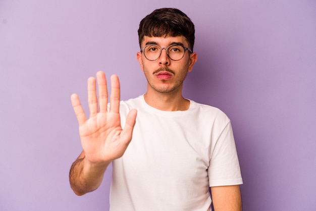 Standing with outstretched hand showing stop sign preventing you