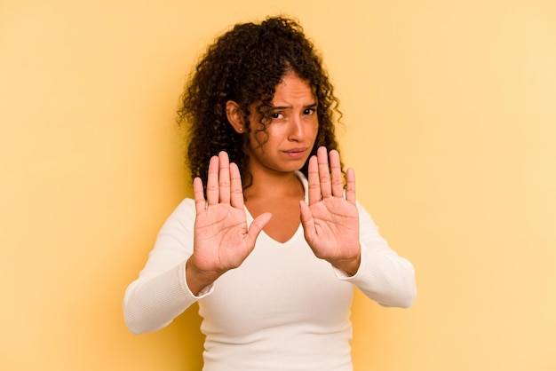 Standing with outstretched hand showing stop sign preventing you