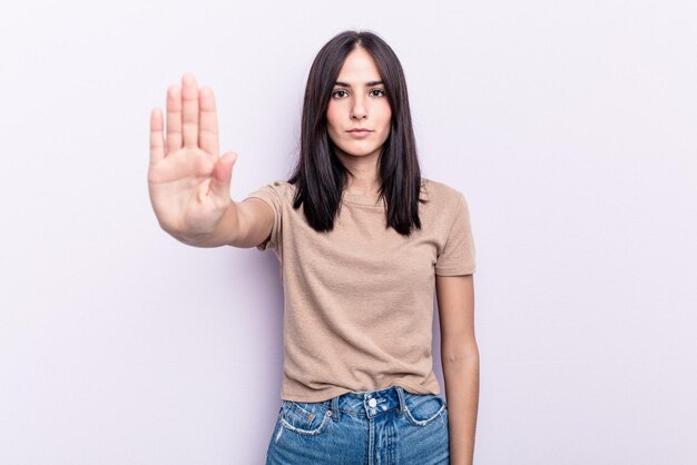 Standing with outstretched hand showing stop sign preventing you