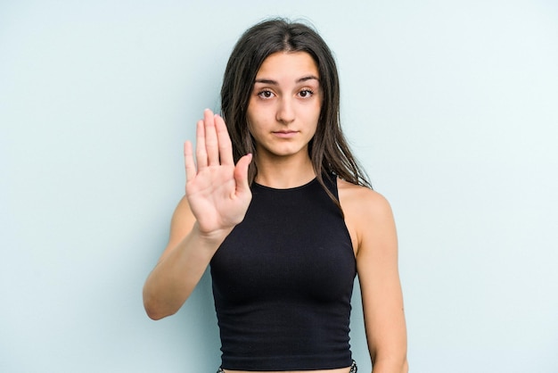 Standing with outstretched hand showing stop sign preventing you