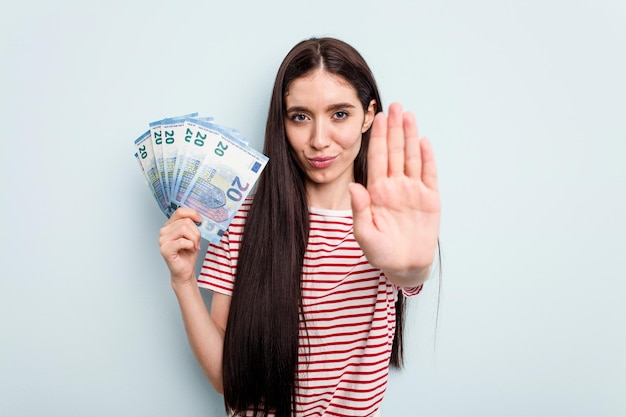 Standing with outstretched hand showing stop sign preventing you