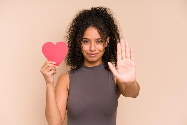 Standing with outstretched hand showing stop sign preventing you