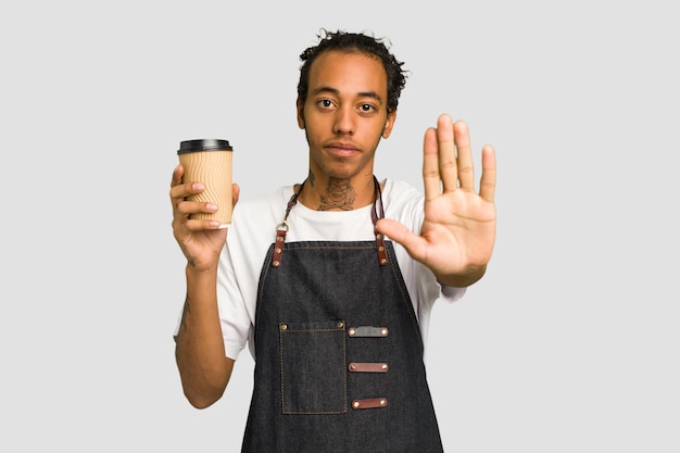 Standing with outstretched hand showing stop sign preventing you