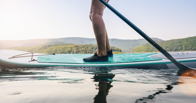 Standup paddler at the lake at summer