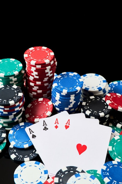 Stapel casino speelpenningen en kaarten geïsoleerd op zwarte reflecterende achtergrond