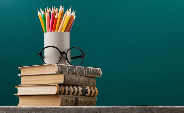 Foto stapel gekleurde studieboeken op een houten bureau