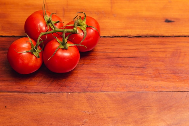 Stapel tomaten op houten tafel met negatieve ruimte aan de rechterkant tomaten houten achtergrond negativ