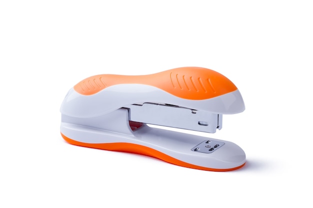 Stapler on white background. Side close-up view of stapler. Orange stapler isolated. Office equipment for paperwork.