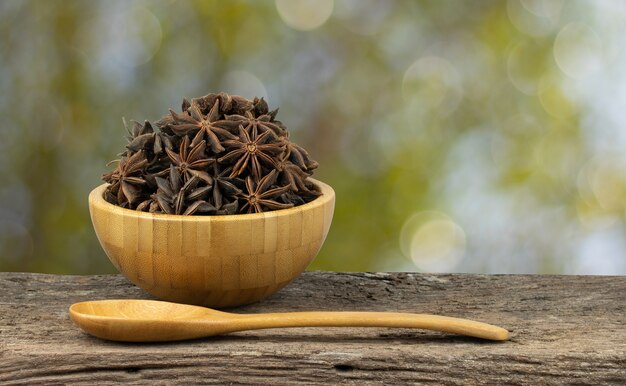 star anise in a bowl on wood table