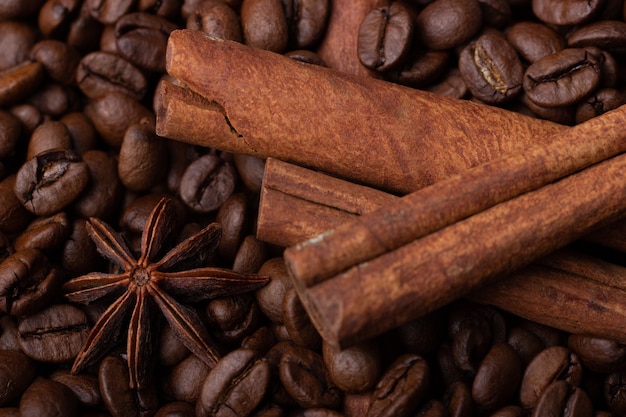 Star anise and cinnamon sticks on coffee beans