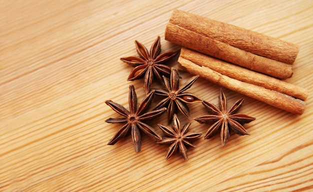 Star anise and cinnamon sticks on a wooden background