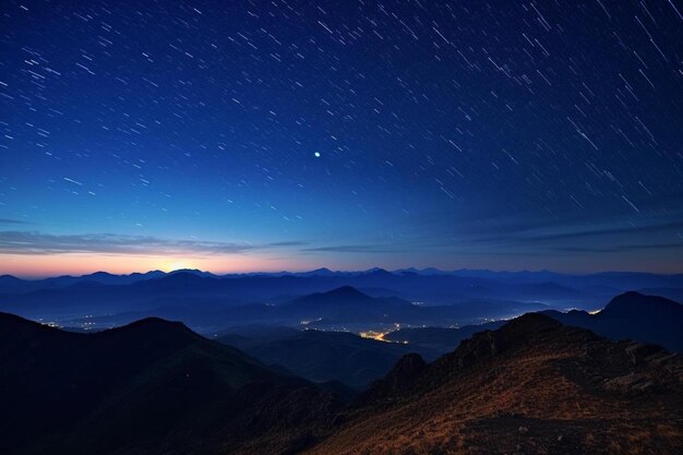 Photo a star filled sky with stars above a mountain