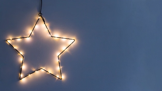 Star made from burning garland on wall