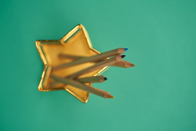 Star shape pencil holder against blackboard