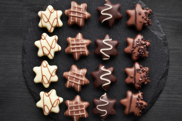 Star-shaped chocolates on dark textured background