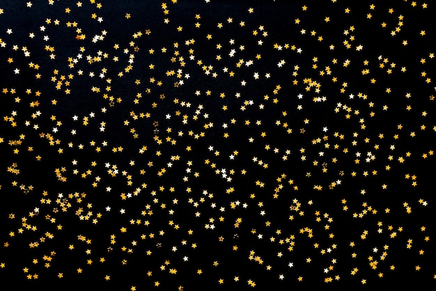 Sfondo di paillettes dorate a forma di stella.