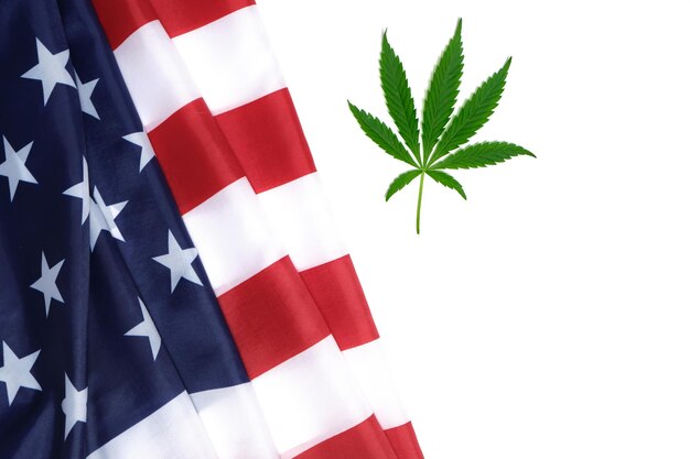 Star spangled flag of the United States of America and a hemp leaf on a white background.