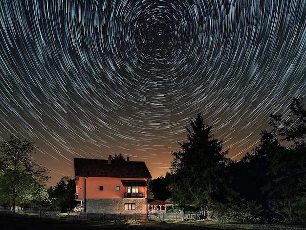 Star trails above the house Residential building and the star trails on the sky