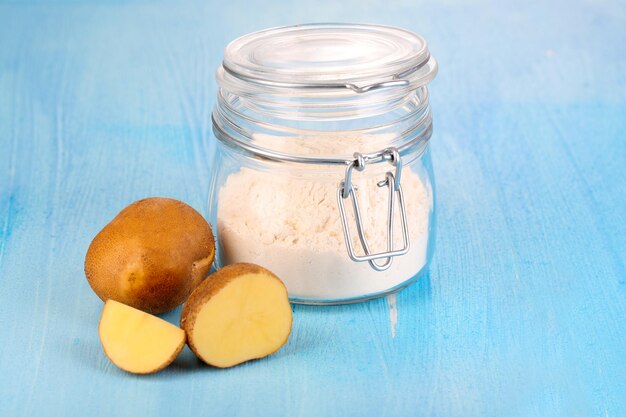 Starch in bank on wooden table closeup